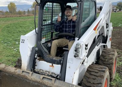 Benv staff member using Skidsteer to backfill for the foundation