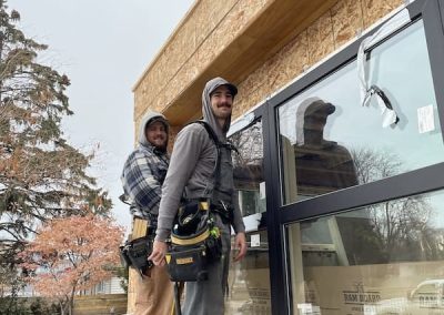 North End carpenters installing windows