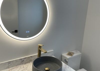 Tupman powder room with lit mirror